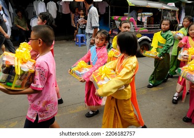 BANGKOK, THAILAND - August 1, 2012. Asahna Bucha Religious School Procession (commemorates Buddha's First Sermon On The Four Noble Truths). Children Carry Gifts For Buddhist Monks Who Begin Fasting.