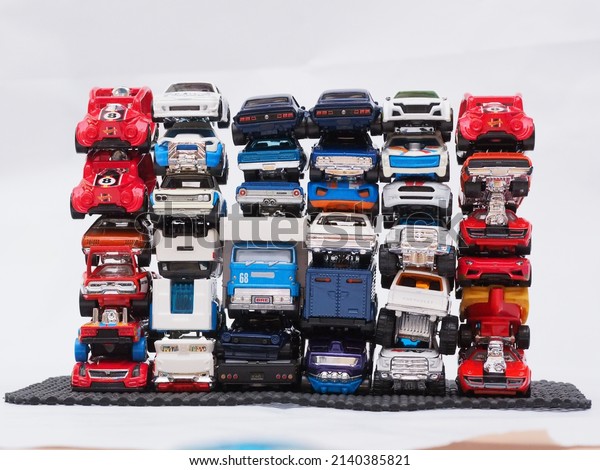 Bangkok, Thailand - August 14, 2021: A stacked\
pile of Hot Wheels cars without using glue to balance the height\
and weight of objects is a way to spend time playing at home during\
COVID-19
