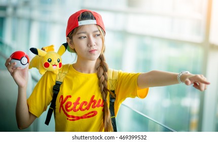 BANGKOK, THAILAND Ã¢?? August 14,2016:  Trainer girl playing pokemon , pokemon ball ,Lighting with sun flare ,Focus on her face