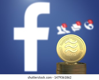 BANGKOK, THAILAND - AUGUST 15th, 2019: Gold Libra Coin On Stack Of Coins With The Facebook Logo Background.