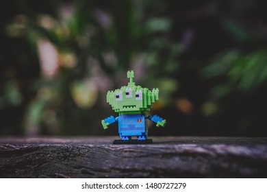 Bangkok, Thailand - August 16, 2019 : Alien Kawaii Mini Block Lego From Toy Story Standing Alone On The Log.