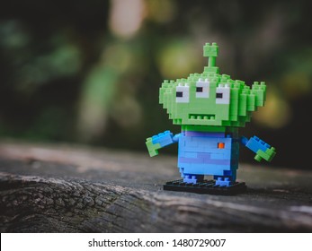 Bangkok, Thailand - August 16, 2019 : Alien Kawaii Mini Block Lego From Toy Story Standing Alone On The Log.