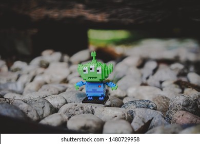 Bangkok, Thailand - August 16, 2019 : Alien Kawaii Mini Block Lego From Toy Story Standing Alone On The Rocks.