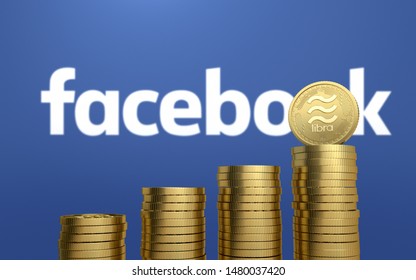 BANGKOK, THAILAND - AUGUST 16th, 2019: Gold Libra Coin On Stack Of Coins With The Facebook Logo Background.