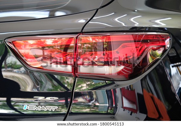 BANGKOK, THAILAND - AUGUST 22, 2020: Close up of MG car\
taillight with shiny black paint & logo detail. Morris Garages\
or MG is British sports car manufacturer. Concept of car brand\
& company. 