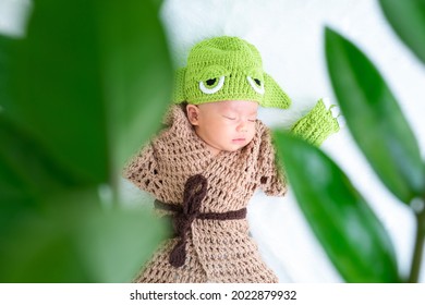 Bangkok, Thailand - August 22, 2021: Cute Newborn Baby In A Grogu Costume. Nature Concept.