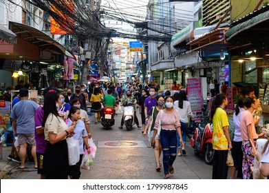 Bangkok, Thailand - August 5, 2020 : Crowd of Thai people wear surgical mask walking to buy food at Phetchaburi 5 Alley, Bangkok