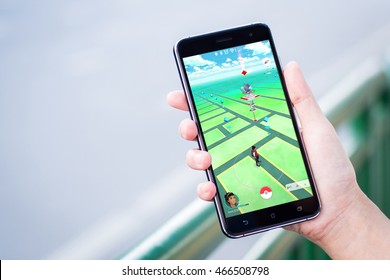 BANGKOK, THAILAND - AUGUST 8: Unidentified Woman Hold A Phone While Playing Pokemon Go In Her Hand By Using An Android Smartphone On August 8,2016 In South Sathorn Road, Bangkok, Thailand.