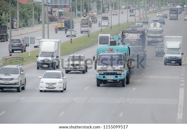 Bangkok, Thailand - August,13: Cars\
running on the road, The truck emits black smoke while running on\
the road. on August,13,2018 in Bangkok,\
Thailand