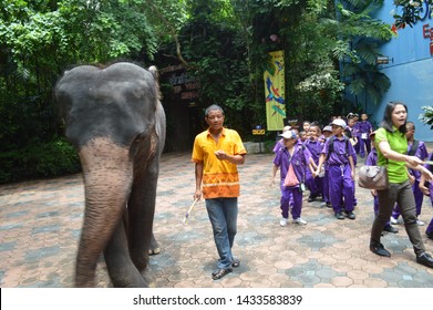 Bangkok, Thailand - Circa 2019. Elephant And Zoo Keeper Walk Through The Place Full Of School Children