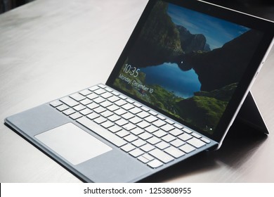 BANGKOK, THAILAND DECEMBER 10 2018: The Microsoft Surface Go Tablet - Computer With Microsoft In Windows 10  Screen And Thai Keyboard Bluetooth On Wooden Desktop In Store