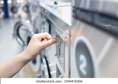 Bangkok / Thailand - December 14, 2019 : Female Hand Put Coin In Luandry Machine