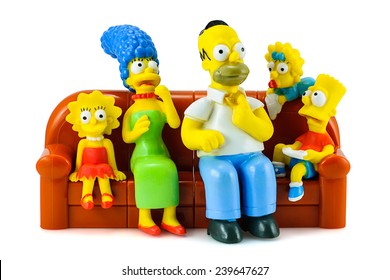 Bangkok, Thailand - December 16, 2014: Simpsons Family On Sofa And See The Scary Movie Figure Toy Character. There Are Plastic Toy Sold As Part Of The Burger King Toys.