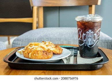 Bangkok Thailand, December 2021,10. Iced Cold Brew Coffee with croissant bakery in Starbuck Coffee cafe.