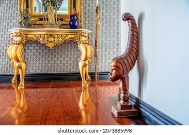 Bangkok Thailand December 5 2016. Home Decorations In A Hall Way. Golden Table With A Mirror On Top. Wooden Sculpture Of A Woman With Closed Eyes On The Floor. Shiny Wooden Floor In A Hall Way.