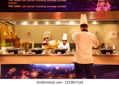 BANGKOK, THAILAND - DECEMBER 6 : Chef and assistant Chefs cooking and prepared buffet food for thai and foreigner people eating at restaurant in night time on December 6, 2018 in Bangkok, Thailand