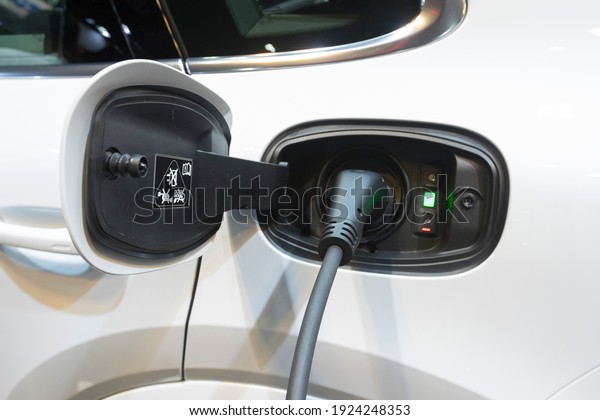 Bangkok, Thailand - December 8,2020 : Close up\
view of Porsche Cayenne electric vehicle charging station with the\
power cable supply plugged in, Bangkok, Thailand on December\
8,2020.