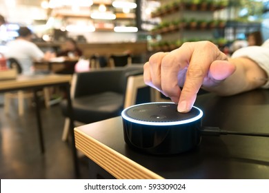 BANGKOK, THAILAND - Fabruary 2 : Finger point to Amazon Echo dot version 2, the voice recognition streaming device from Amazon in coffee shop on Fabruary 2 2017 in BANGKOK, THAILAND