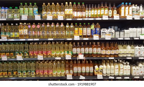 Bangkok, Thailand - Feb 2021: Wide range of imported extra virgin olive oil display on the shelf at local grocery store or shopping mall.  