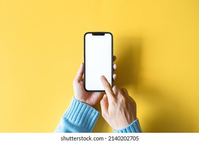 Bangkok, Thailand - Feb 3, 2022: Close Up Hand Holding Black Smartphone IPhone 12 Pro Max With White Screen. Isolated On White Background. Mobile Phone Frameless Design Concept.