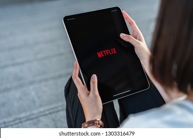 Bangkok, Thailand - February 04, 2019 : Women Use Netflix App On IPad Pro Screen. Netflix Is An International Leading Subscription Service For Watching TV Episodes And Movies.