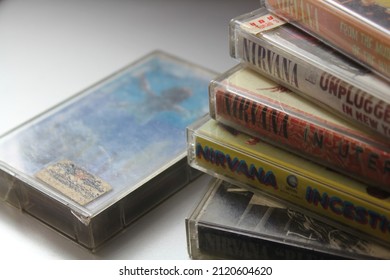 Bangkok, Thailand - February ,09 2022 : 90's Cassette Tapes Of Nirvana Albums Incesticide, Nevermind, Bleach, From The Muddy Banks Of The Wishkah, Unplugged In New York On A Gray Floor.