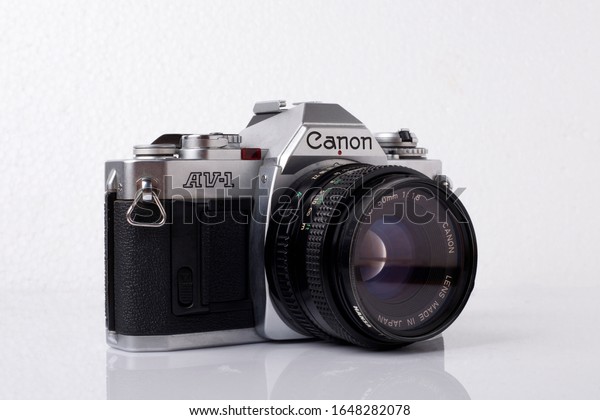 BANGKOK, THAILAND - February 12,\
2020 :  Canon AV-1, Film camera interchangeable lens camera, with\
50 mm lens on white background, Illustrative\
Editorial.