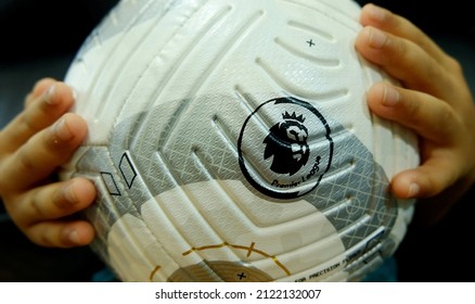 BANGKOK, THAILAND - FEBRUARY 12, 2022: Nike Premier League Strike Ball on kid hands.