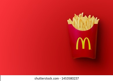 Bangkok ,Thailand - February 14 2019 : McDonald's French fries in the French fries box on red background. McDonald's Corporation is the world's largest fast food restaurant.