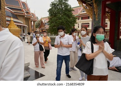 Bangkok, Thailand, February, 16, 2022: Group Of People Praying While Standing Outside A Buddhist Temple