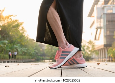 BANGKOK, THAILAND - FEBRUARY 17, 2018 : Women Wearing Adidas Swift Run W 2017 Sports Shoes For Running For Women On Street Outdoor - Illustration Editorial