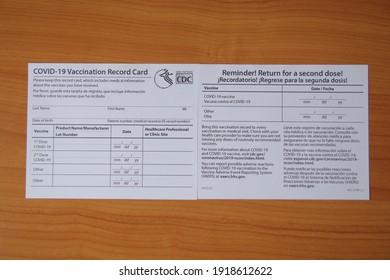 Bangkok, Thailand - February 17 2021: COVID-19 Vaccination record card by CDC, Vaccination form during the coronavirus epidemic on table background