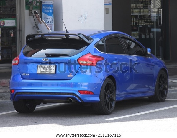 Bangkok, Thailand - february 19 2020: private fwd\
front wheel drive deep sky blue metallic color american european\
midsize sport hatchback Thai Ford Focus 3 III Gen, car parking on\
street in rest area