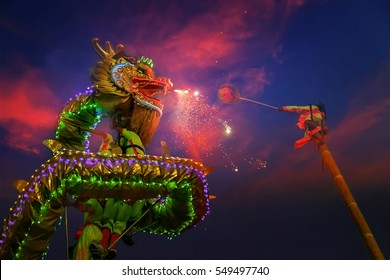 BANGKOK, THAILAND - FEBRUARY 20 2015: Unidentified group of people perform a traditional dragon dance at Rama IX public park to celebrate traditional Chinese's lunar new year