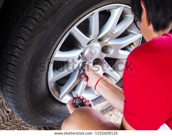 Bangkok, Thailand - February\
24, 2019: Changing the tire wheels When there is a problem of\
cracking and leakage in order to prevent accidents on the road\
during driving