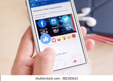 Bangkok, Thailand - February 26, 2016: Hand Holding IPhone With New Facebook Like Button (6 Emoji) On Screen ,Social Media Are Using For Information Sharing And Networking.