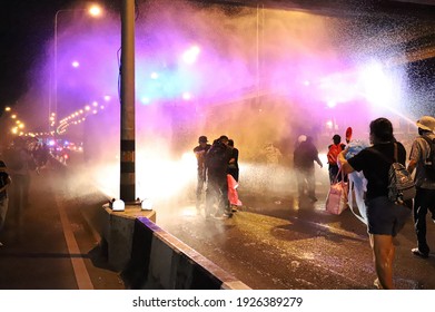 Bangkok, THAILAND - February 28, 2021: Riot police used High-pressure water cannon fire protester during rally protest to Prayut Chan-o-cha's house at 1st Infantry Regiment.