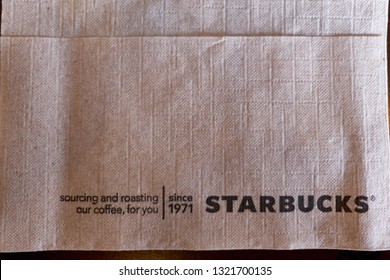 BANGKOK, THAILAND- FEBRUARY 6, 2019 : Close Up Of Starbucks Napkins On Wooden Table. Napkin Paper Made With Recycled Content & Post Consumer Fiber To Help Preserve Trees. Environment Concept.