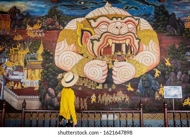 Bangkok, Thailand - Jan 18, 2020 : Young Asian Woman Traveler At Temple Of The Emerald Buddha Or WAT PHRA KAEW In Bangkok, Thailand. Female Tourists Looking At Painting Mural On Holiday Travel.