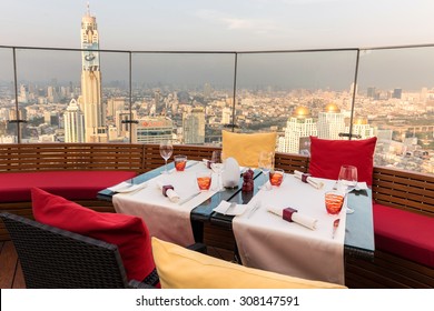 BANGKOK, THAILAND, JANUARY 14, 2015: Restaurant table with view on the Baiyoke tower and cityscape at the Red Sky Rooftop of the Centara hotel in Bangkok, Thailand.