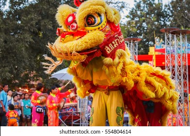 BANGKOK, THAILAND - JANUARY 14 2016: Unidentified group of people perform a traditional lion dance at Rama IX public park to celebrate traditional Chinese's lunar new year