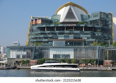 BANGKOK, THAILAND - JANUARY 15, 2022: Electric catamaran "Mine Smart Ferry" in front of luxury shopping-mall Iconsiam on January 15, 2022 in Thai capital Bangkok