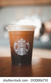 Bangkok, Thailand - January 19, 2021 : Starbucks Nitro Cold Brew Coffee in the Starbucks take away plastic cup. Starbucks is the world's largest coffee house with over 20,000 stores in 61 countries.