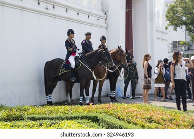 BANGKOK, THAILAND - JANUARY 24, 2015: Wat Phra Kaew in Bangkok, Thailand. Unidentified Royal Horse Guards are on duty at Thai Grand palace