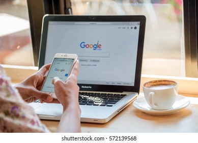 Bangkok. Thailand. January 24, 2017: A woman is typing on Google search engine from a laptop. Google search  with the new Google logo is the biggest Internet search engine in the world.