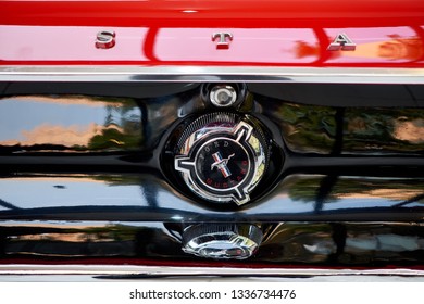 BANGKOK, THAILAND - JANUARY 28, 2019: Close up of Ford Mustang classic logo on fuel cap & emblem on shiny red bonnet trunk. Vintage chrome gas lid. Retro & classic car restoration concept. - Shutterstock ID 1336734476