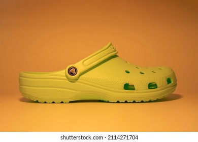 Bangkok, Thailand - January 28, 2022 : A Green Crocs Sandal With Motif Design Isolated On Yellow Background.