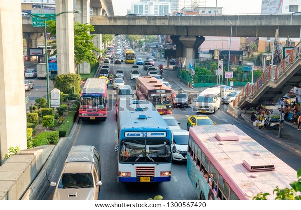 BANGKOK, THAILAND - January 30: Victory\
Monument on January 30,2019 in Bangkok, Thailand. Bus Cars on the\
city street. Traffic jam in the rush hour\
