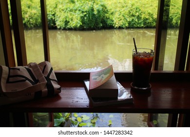 Bangkok / Thailand - July 10 2019: Relaxing On Weekend By Having Coffee And Reading A Book, Crazy Rich Asian