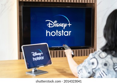 Bangkok, Thailand - July 13, 2021: Disney+ Hotstar Movie App Logo On Ipad And Smart TV Television Screen Sharing In Home Living Room For Popular TV Show Watching During New Normal Lifestyle